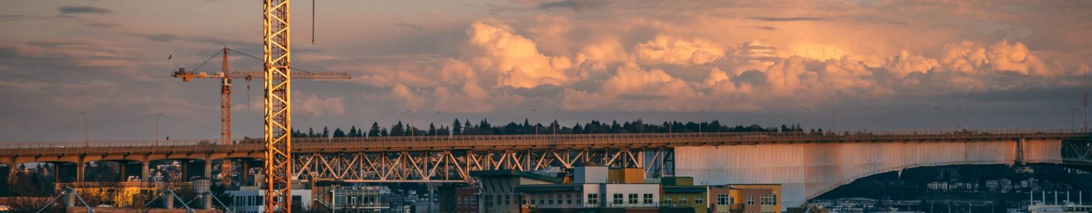 A beautiful view of a construction site in a city during sunset